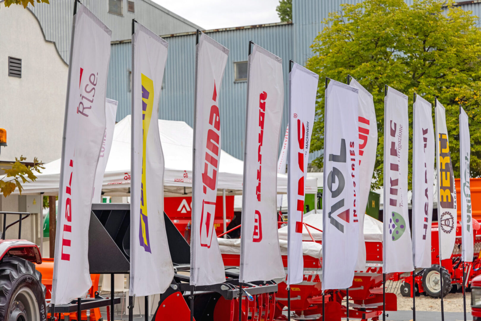 Row of branded flags near machinery