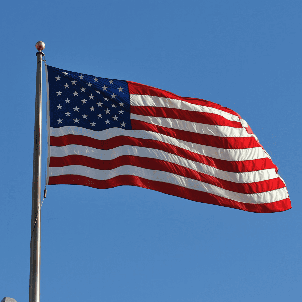 American flag waving on flagpole against sky